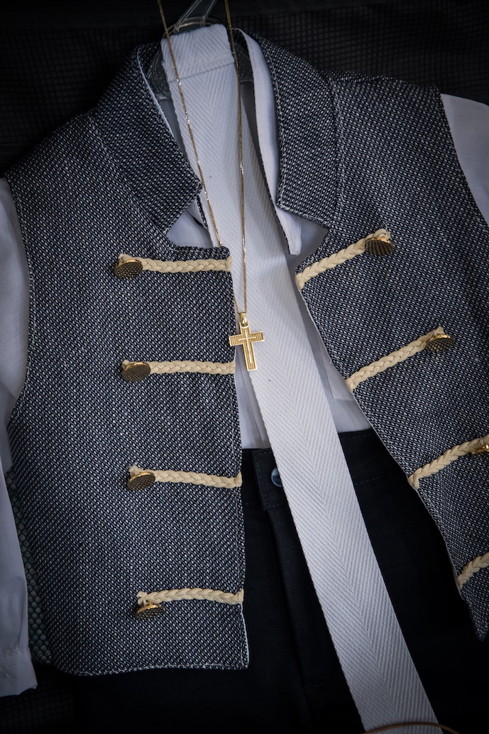 A baby boy's baptism outfit and a gold cross.