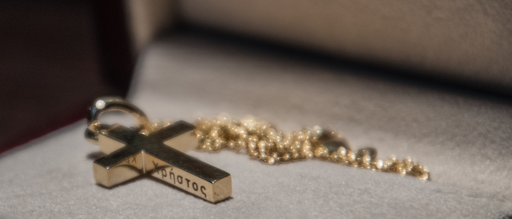 Close-up details of a gold cross for a holy baptism.