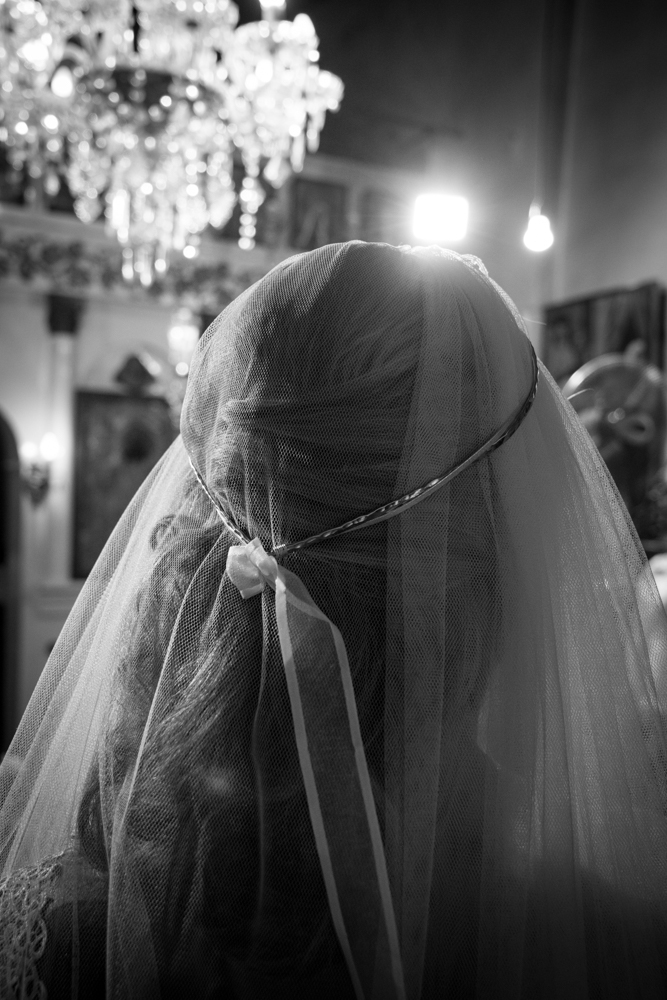 Close-up detail of a bride's veil in a Greek church.