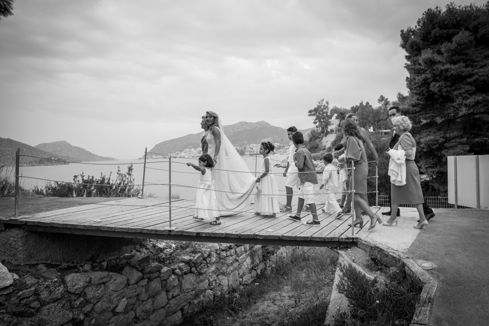 A happy bride surrounded by her family by the sea in Greece.